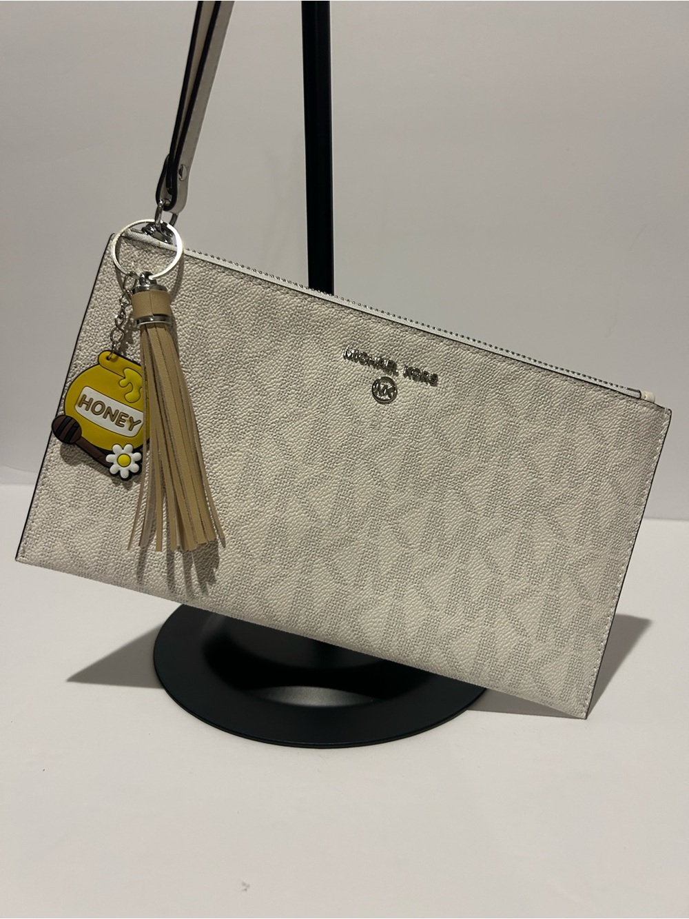 Michael Kors Cream Signature Wristlet with Tassel Charm